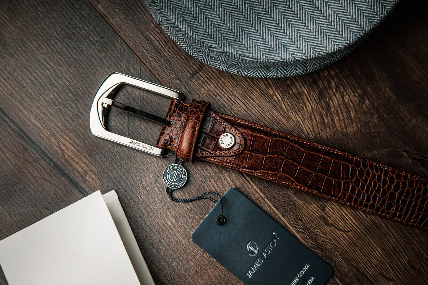 The Alessandro dress belt in cognac embossed leather, composed.