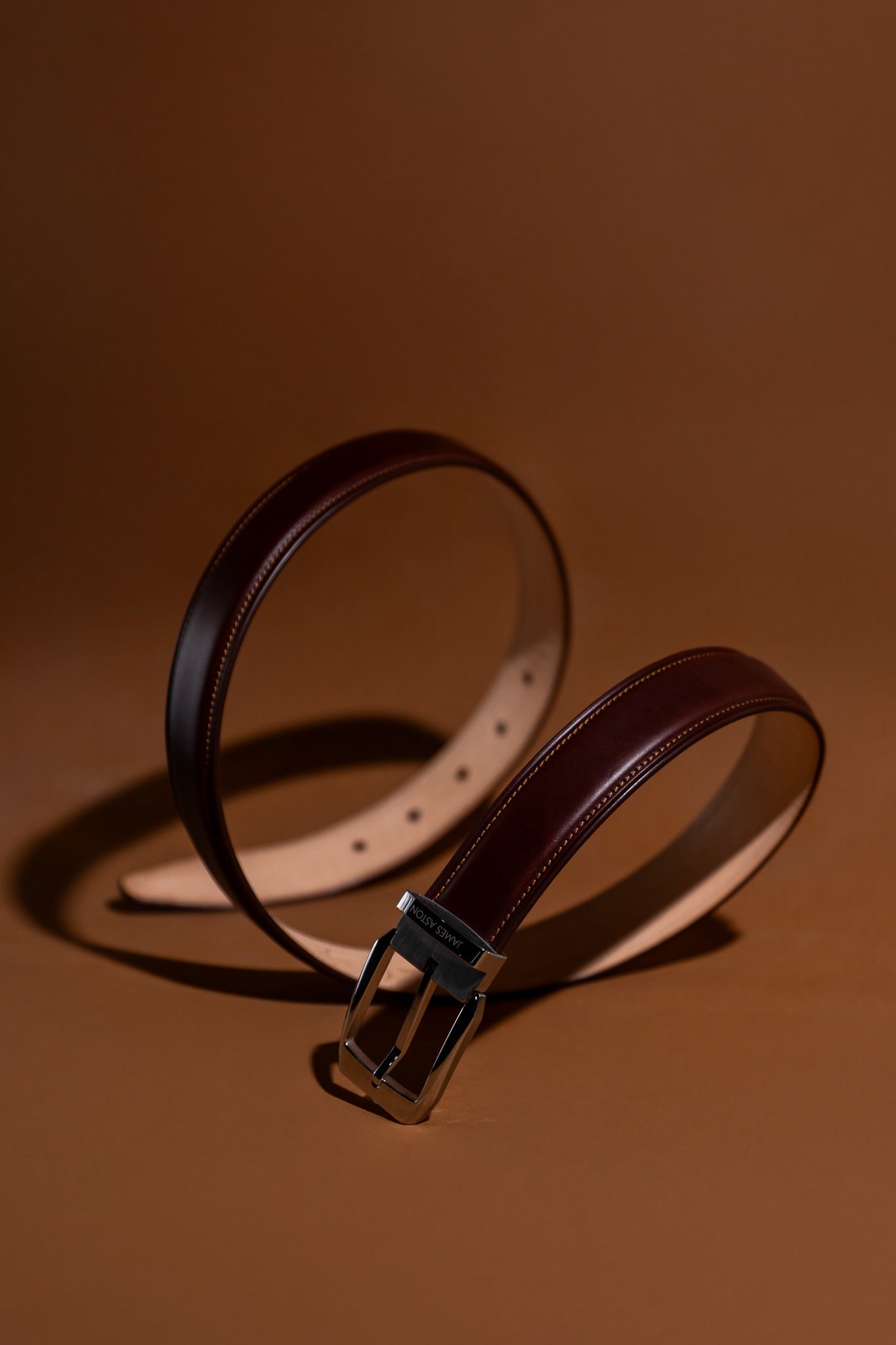 The Cosimo oak brown Italian Bridle leather belt in warm light, showing the depth of the leather