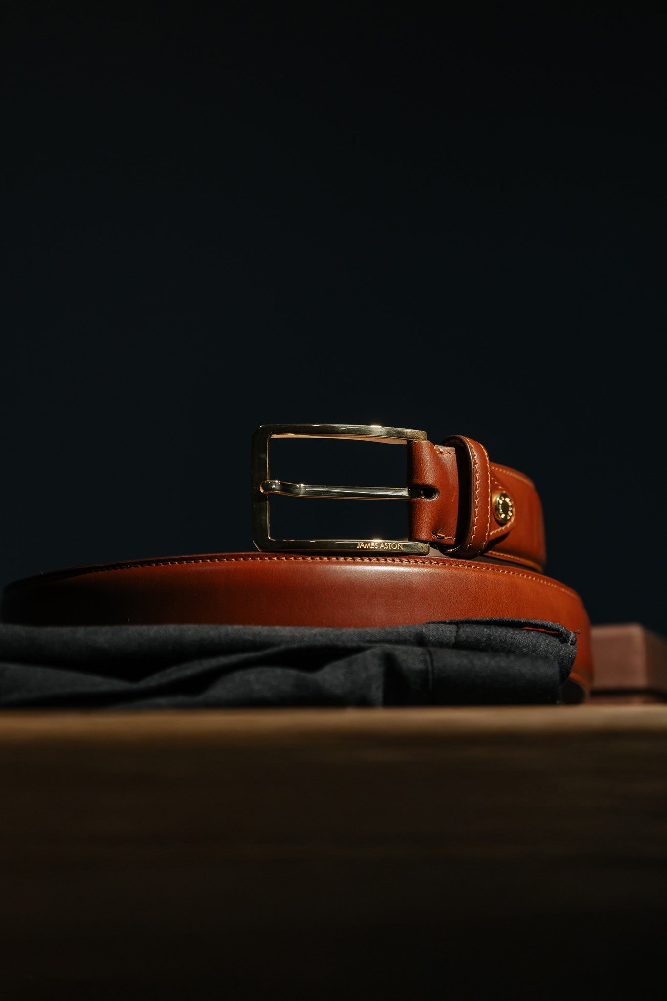 The Lorenzo cognac Italian Bridle leather belt in warm light, showing the amber depth of the leather