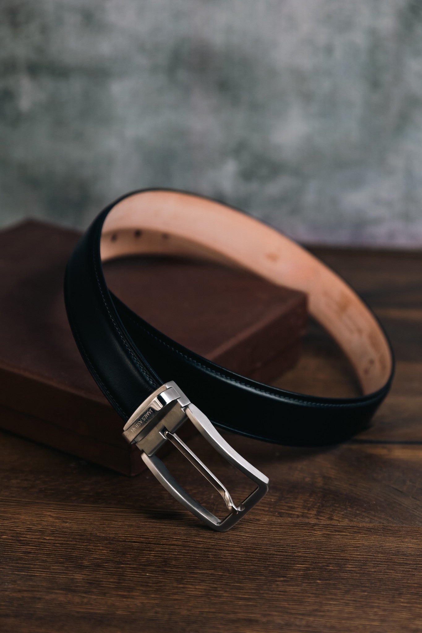 The Cesare Black Italian Bridle leather belt in warm light, showing the depth of the leather