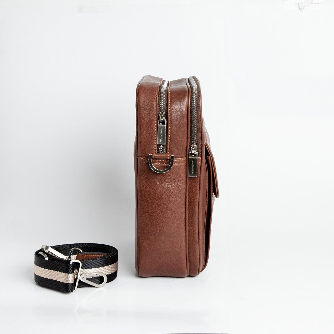 Side profile of The Minimal Sling cognac leather sling bag.