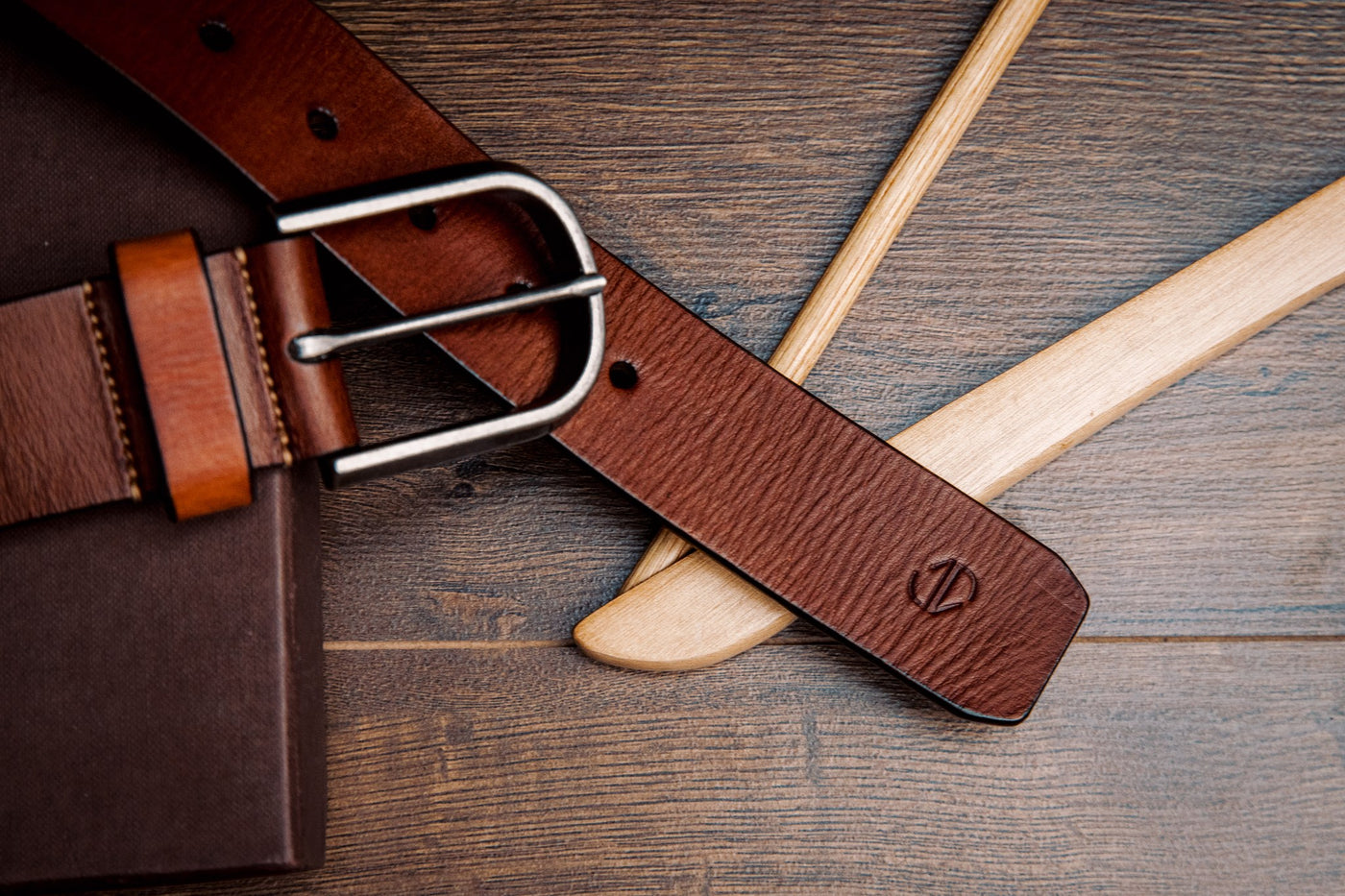 Close view of the milled leather grain of the Pedro belt in cognac