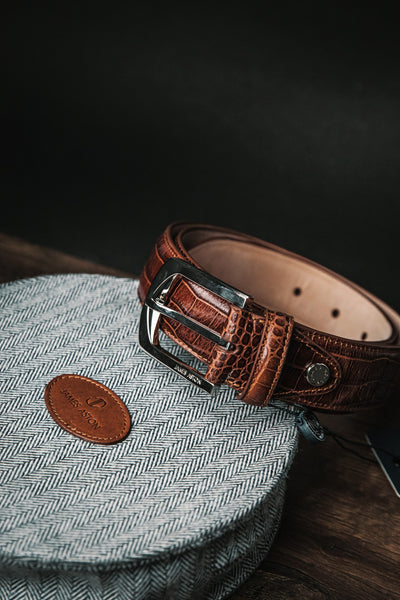 The embossed grain of the Alessandro dress belt in cognac.