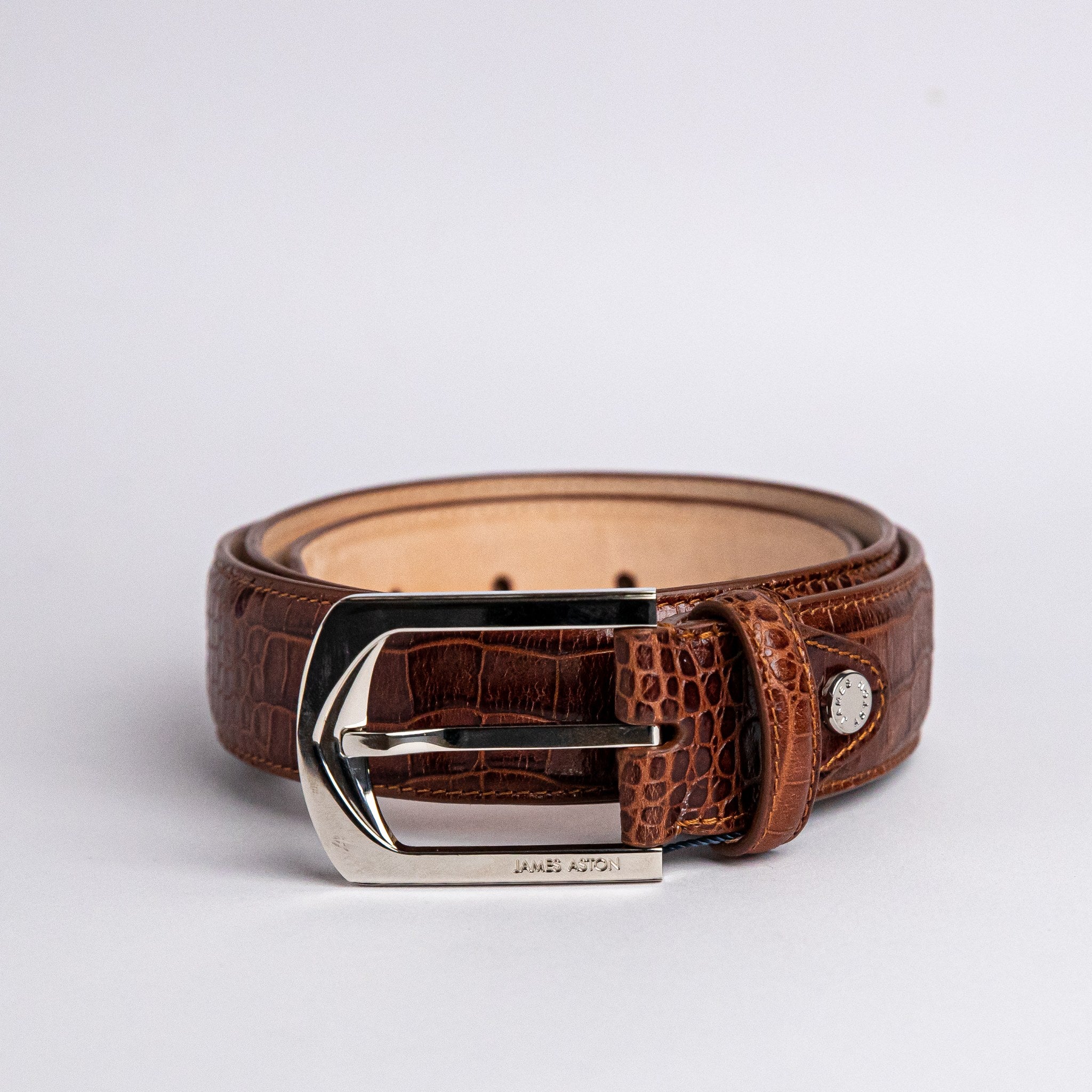 The Alessandro dress belt in cognac embossed leather, full length.