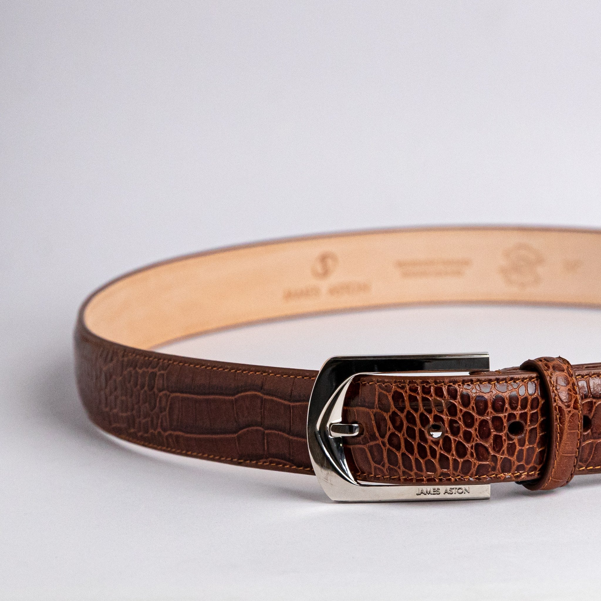 The solid brass buckle of the Alessandro dress belt in a nickel finish.