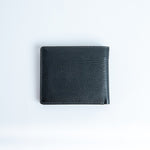 The back of the Alonzo bifold wallet in black milled Vachetta leather.