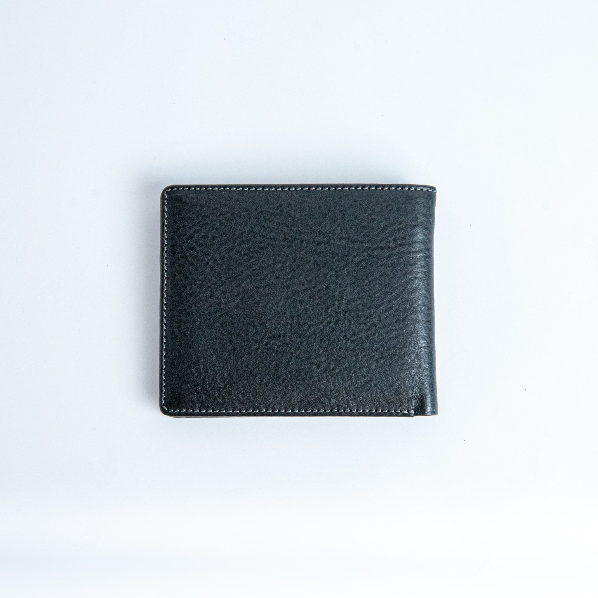 The back of the Alonzo bifold wallet in black milled Vachetta leather.