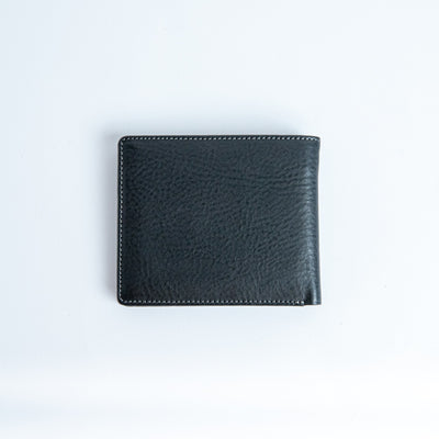 The back of the Alonzo bifold wallet in black milled Vachetta leather.