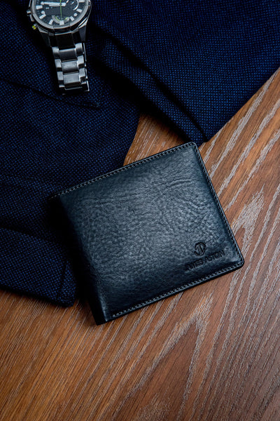 The milled Vachetta leather of the Alonzo bifold wallet in black.