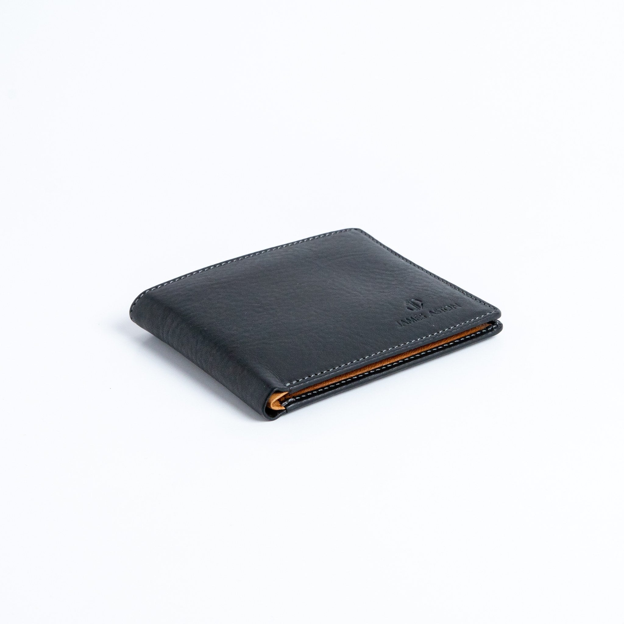 The Alonzo bifold wallet in black milled Vachetta leather.