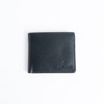 The Alonzo bifold wallet in black milled Vachetta leather, closed.
