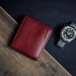 The milled Vachetta leather of the Alonzo bifold wallet in red.
