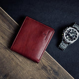 The milled Vachetta leather of the Alonzo bifold wallet in red.