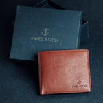 The Alonzo bifold wallet in red milled Vachetta leather, composed.