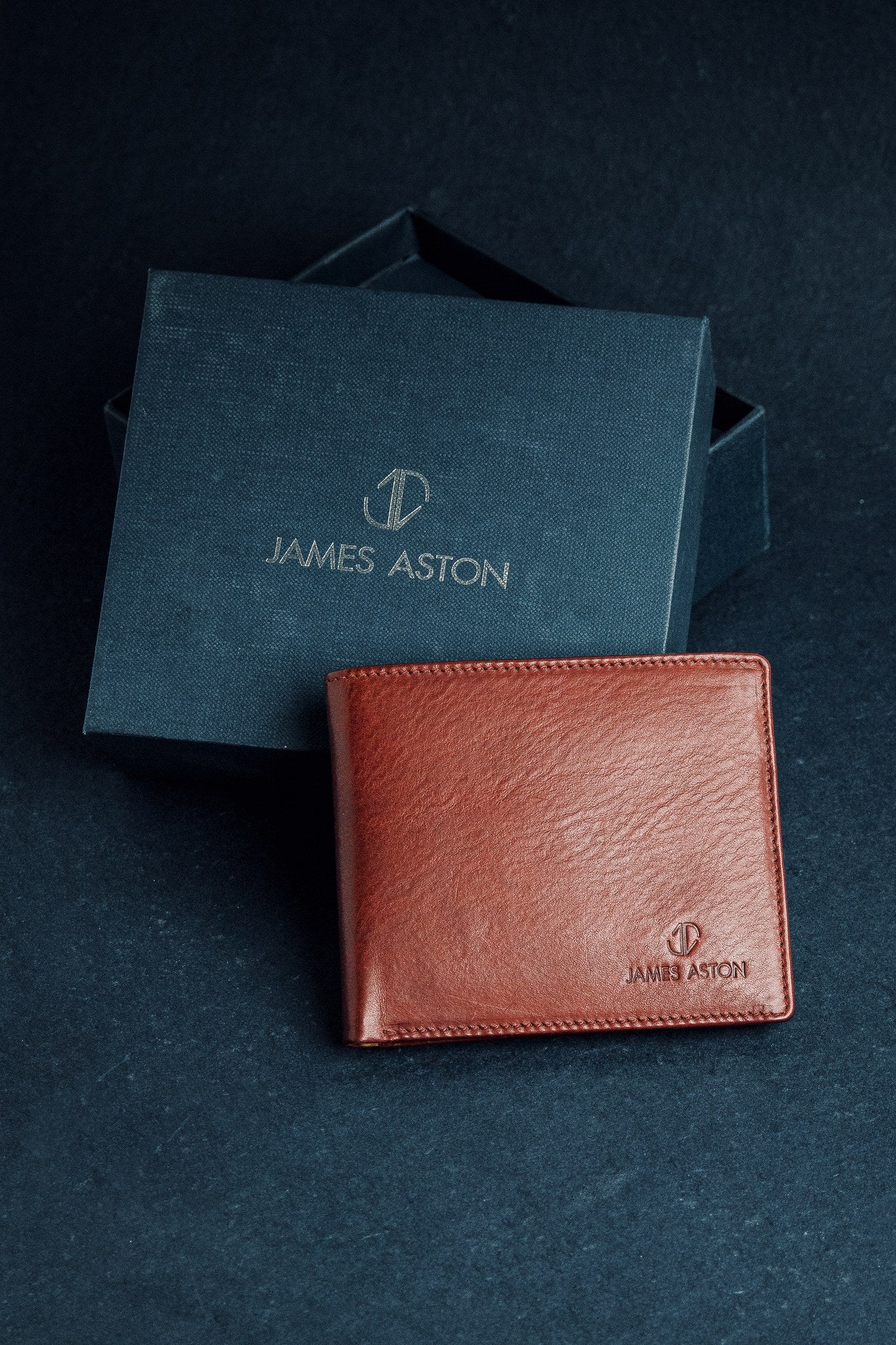 The Alonzo bifold wallet in red milled Vachetta leather, composed.