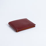 The Alonzo bifold wallet in red milled Vachetta leather.
