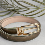 The Anna dress belt in olive Vachetta leather, composed.