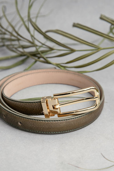 The Anna dress belt in olive Vachetta leather, composed.