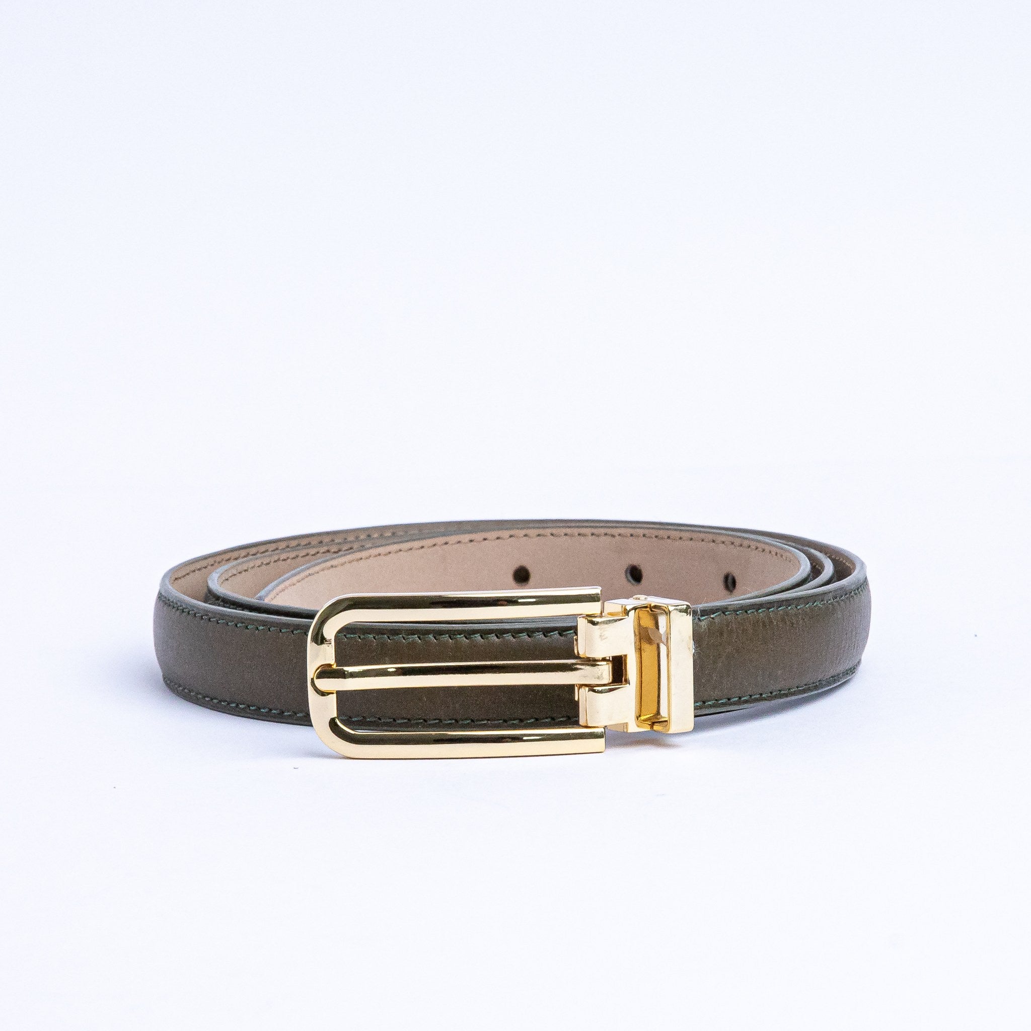The gold buckle of the Anna Vachetta dress belt in olive.