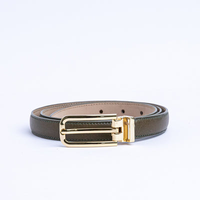 The gold buckle of the Anna Vachetta dress belt in olive.
