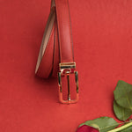 The natural Vachetta leather of the Anna dress belt in red.