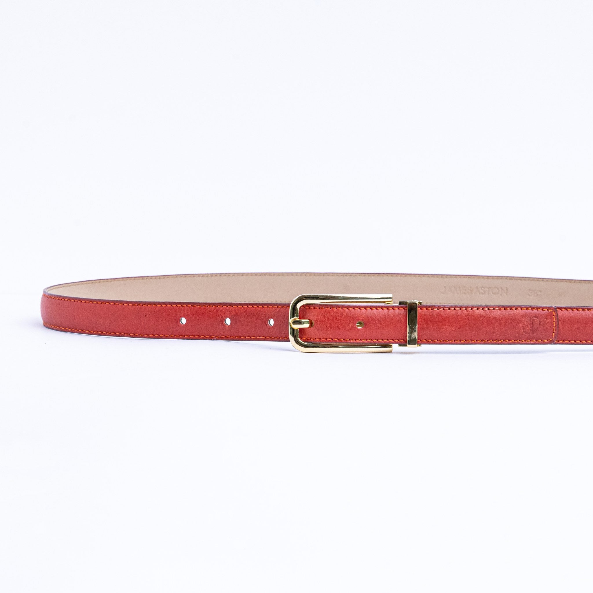 The Anna dress belt in red Vachetta leather, full length, with gold buckle.
