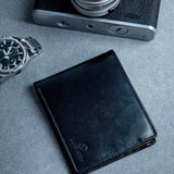 The English Bridle leather of the Bristol bifold wallet in black.