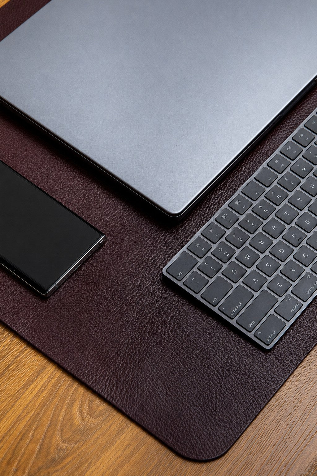 The large desk mat in Australian Nut, composed on a desk