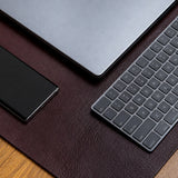 The large desk mat in Australian Nut, composed on a desk