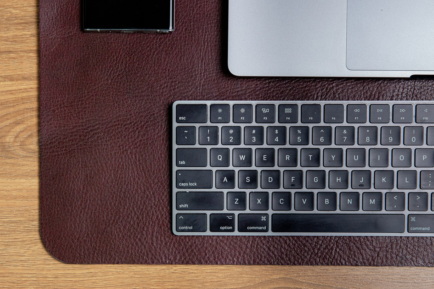 The large desk mat in Australian Nut, in use