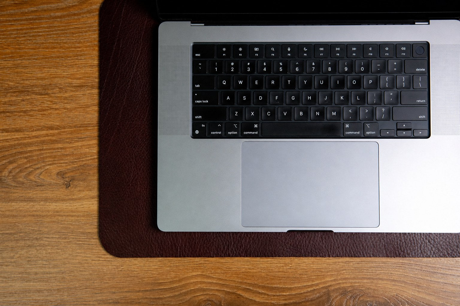 The medium desk mat in Australian Nut, composed on a desk