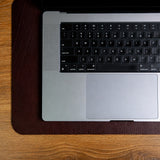 The medium desk mat in Australian Nut, composed on a desk