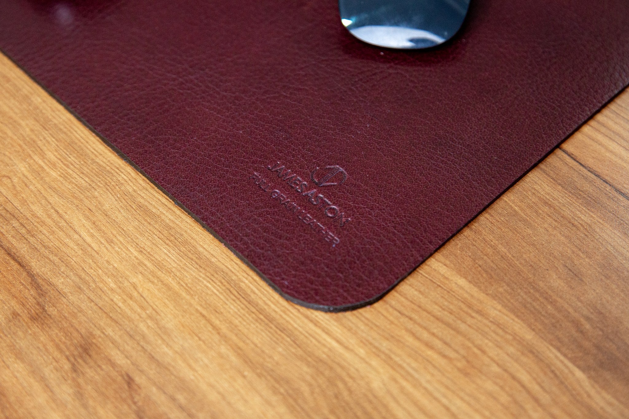 The full grain milled leather grain of the desk mat in Australian Nut