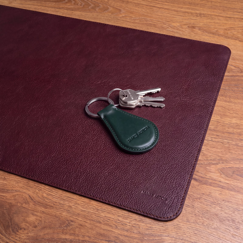James Aston leather accessories, burgundy leather desk mat and bottle green key holder