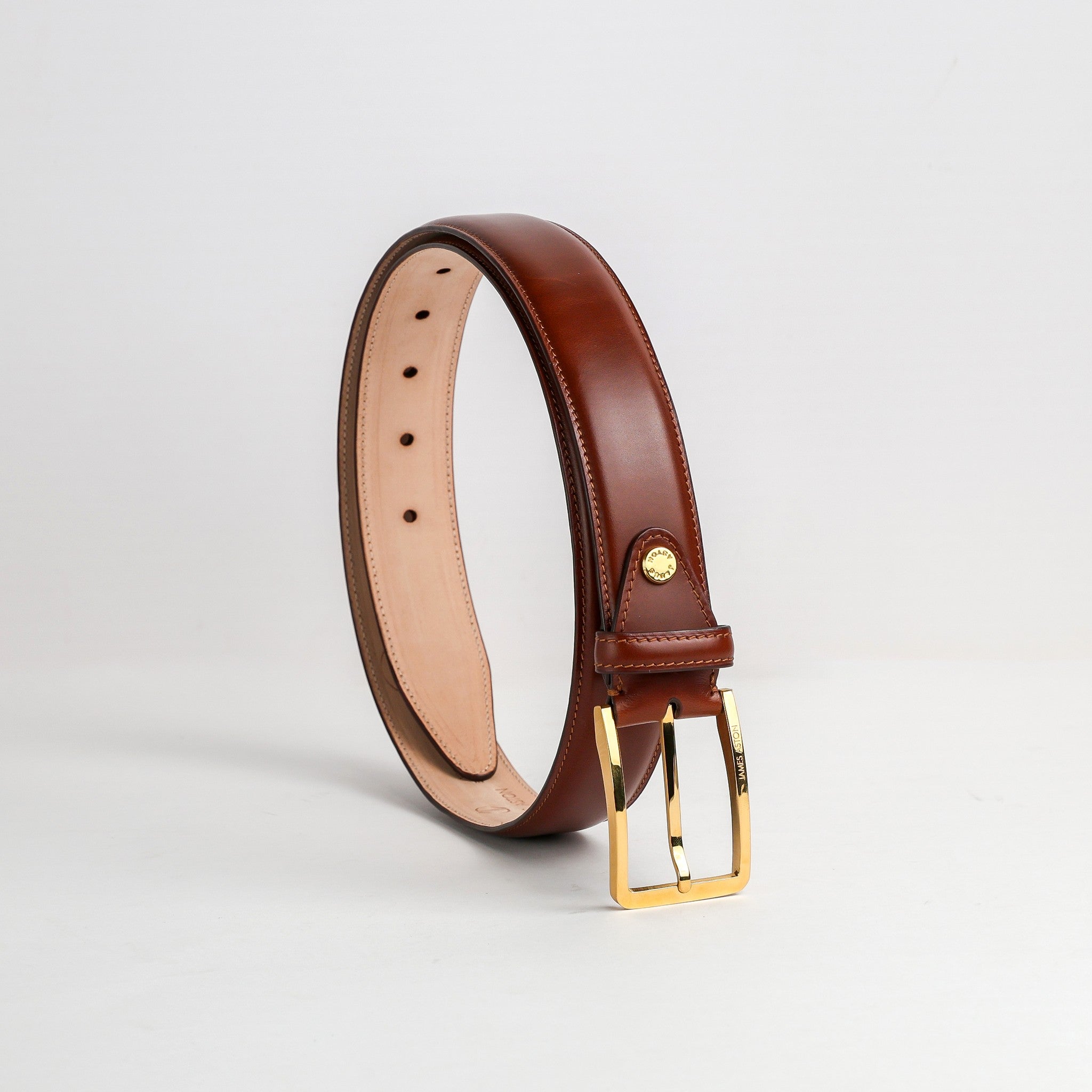 The Lorenzo belt in cognac Italian vegetable tanned Bridle leather, with its gold buckle, by James Aston