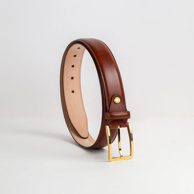 The Lorenzo belt in cognac Italian vegetable tanned Bridle leather, with its gold buckle, by James Aston