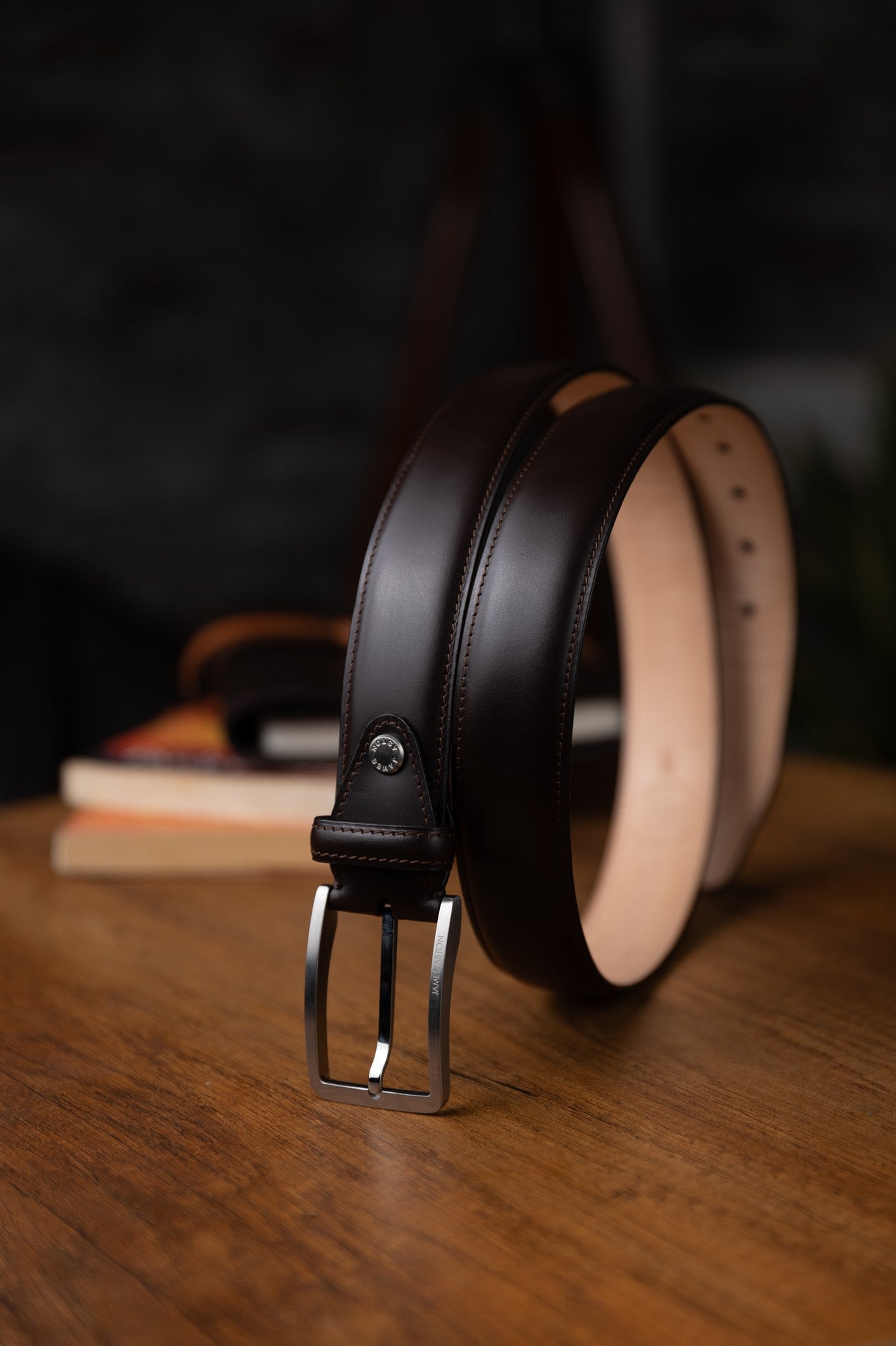 The Lorenzo dark brown Italian Bridle leather belt in warm light, showing the depth of the leather