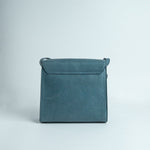 The back of Ocean's Bloom blue leather handbag.