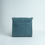The back of Ocean's Bloom blue leather handbag.