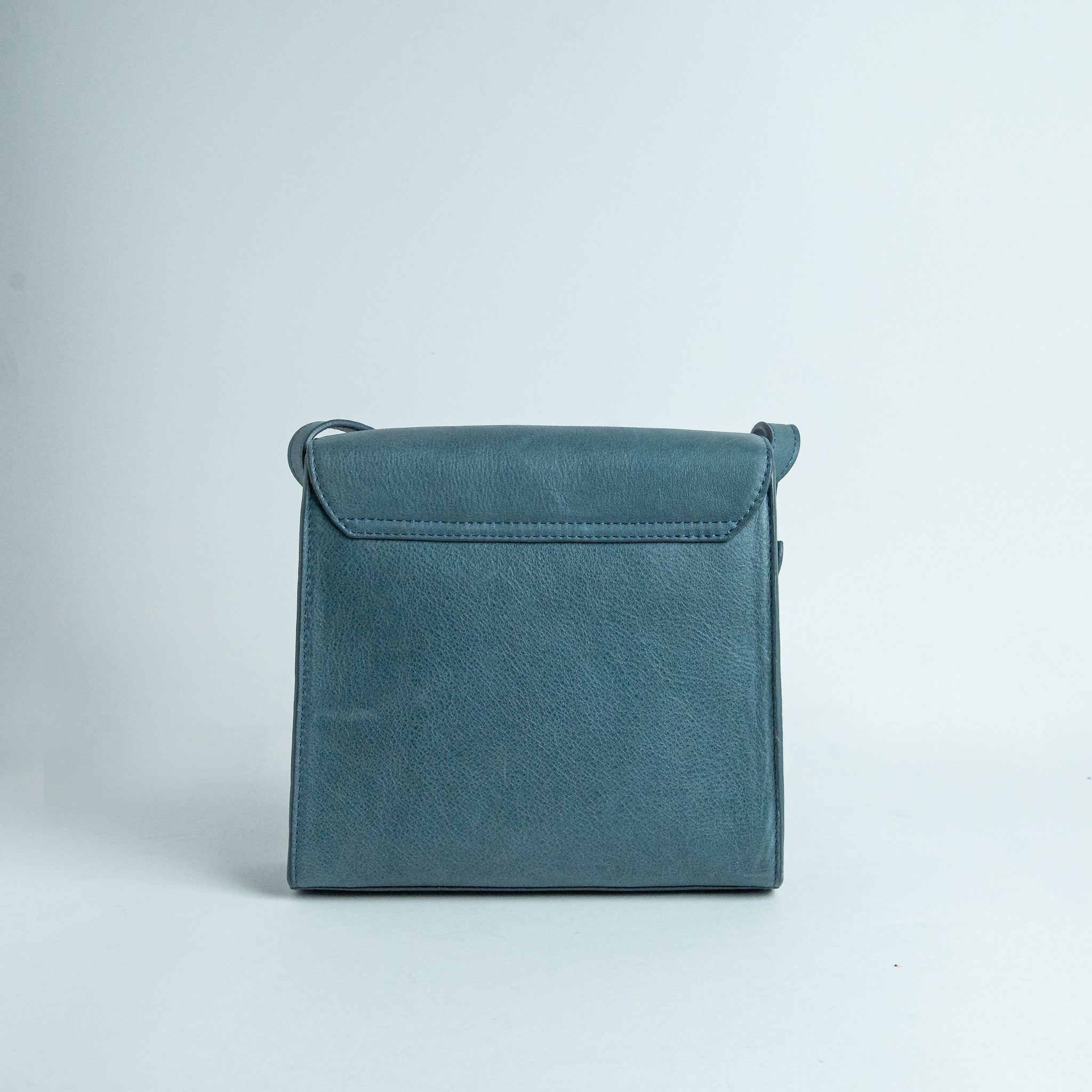 The back of Ocean's Bloom blue leather handbag.