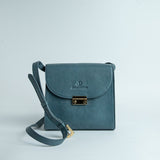 Ocean's Bloom Spanish milled leather handbag in blue, front view.
