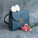 Ocean's Bloom blue leather handbag, carried across the body.