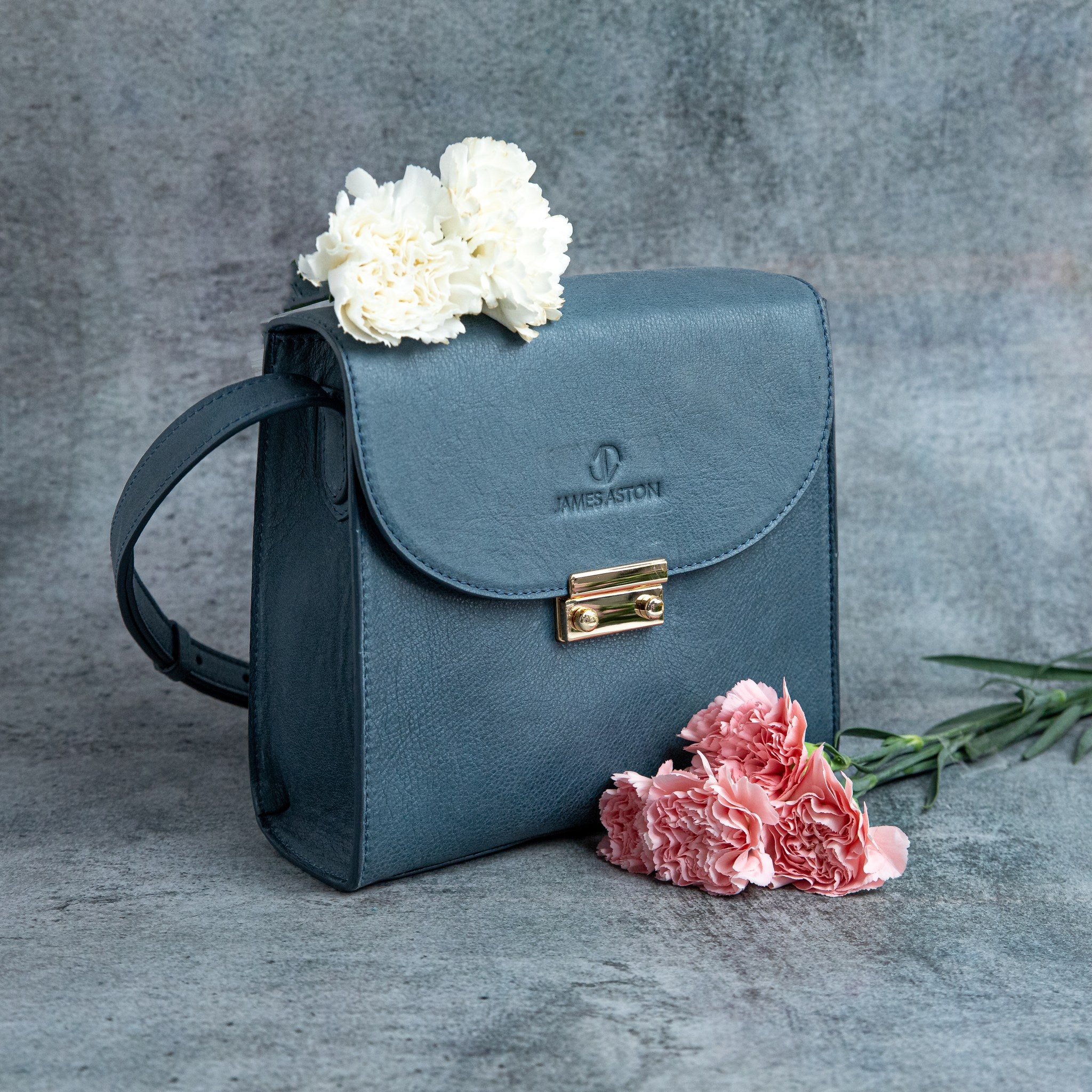 Ocean's Bloom blue leather handbag, carried across the body.