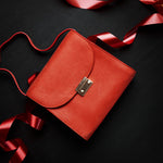 Ocean's Bloom orange peach leather handbag, carried.
