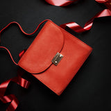 Ocean's Bloom orange peach leather handbag, carried.
