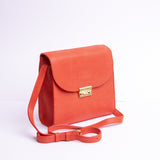 Side profile of Ocean's Bloom orange peach leather handbag.