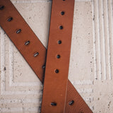 The Alarico belt in tan milled leather shown at full length, with dull nickel buckle