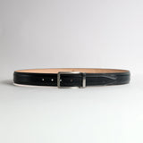 The Cesare black Bridle leather belt flat lay showing embossed JA mark on billet tip and engraved James Aston keeper