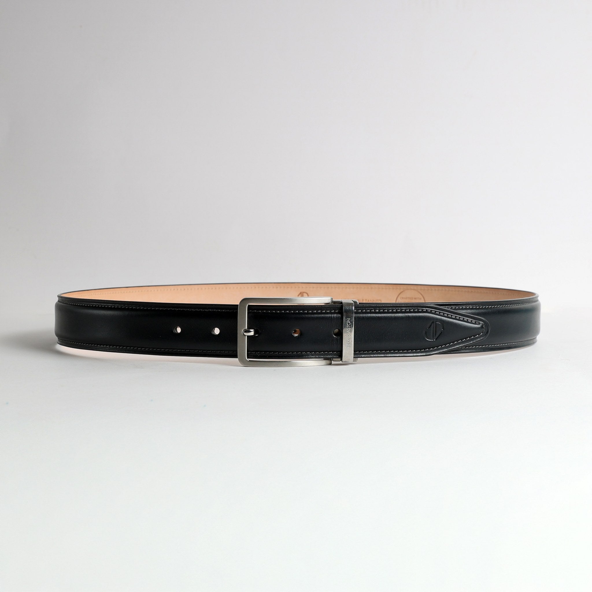 The Cesare black Bridle leather belt flat lay showing embossed JA mark on billet tip and engraved James Aston keeper