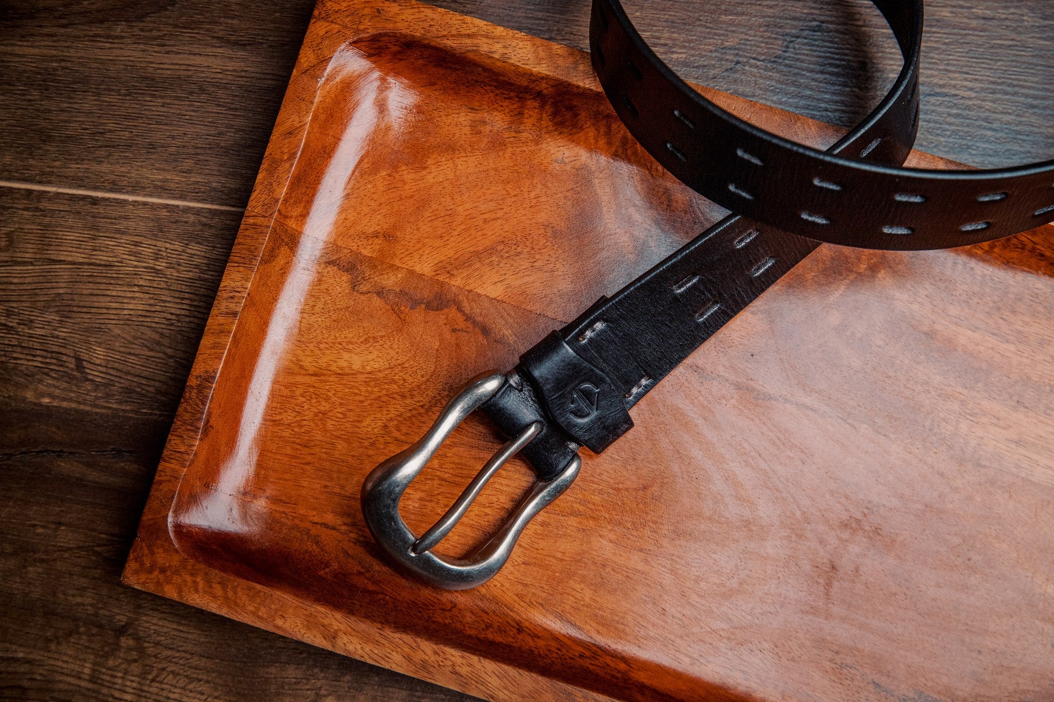 The Damian belt in black milled leather shown at full length, with dull nickel buckle